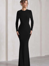 Woman wearing a round neck long sleeve bodycon maxi dress in black