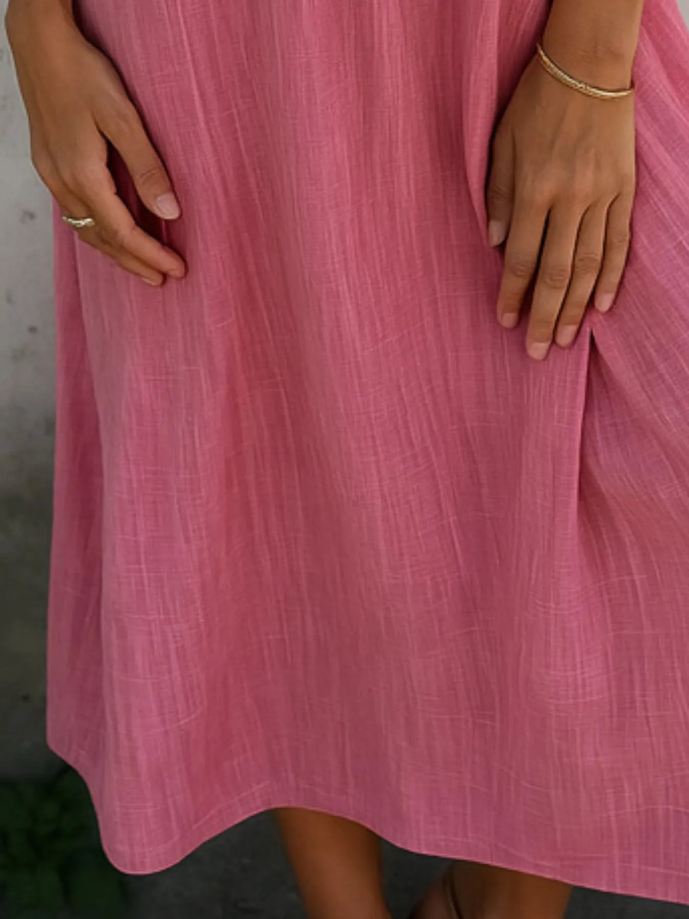 Full Size Short Sleeve Shirt Dress with Collar Plus Size in soft pink fabric, showcasing hands on the dress.