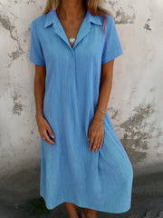 Full Size Short Sleeve Shirt Dress with Collar Plus Size in light blue worn by a model against a textured background.