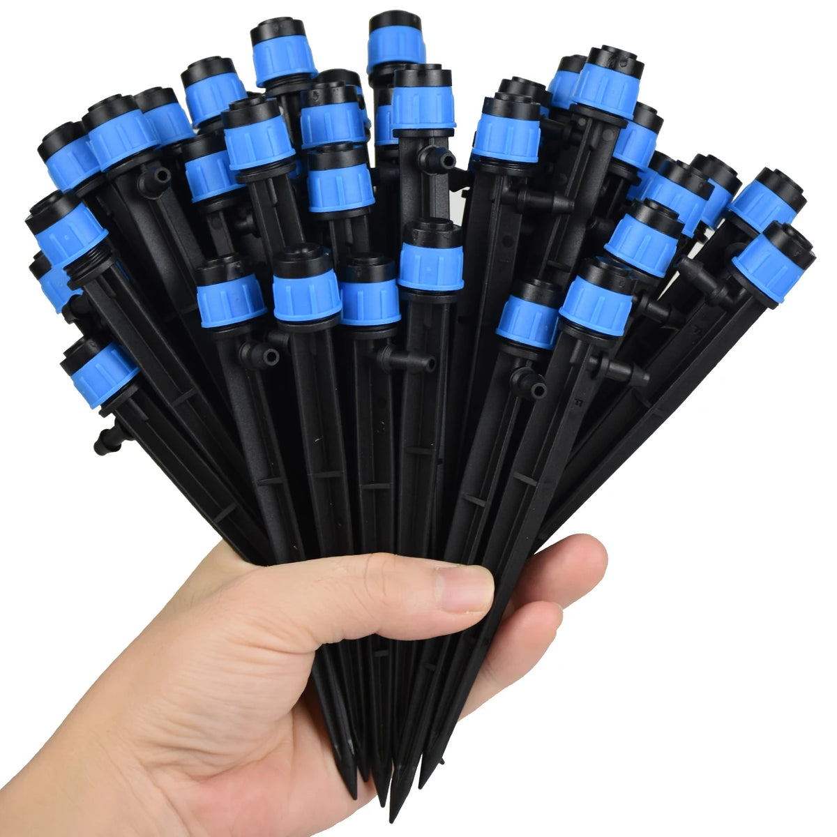 Adjustable spike sprinklers for drip tubing